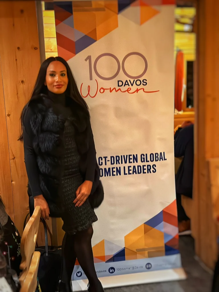 Temi Marcella Olatunde with the 100 Davos Women banner, Davos 2023.