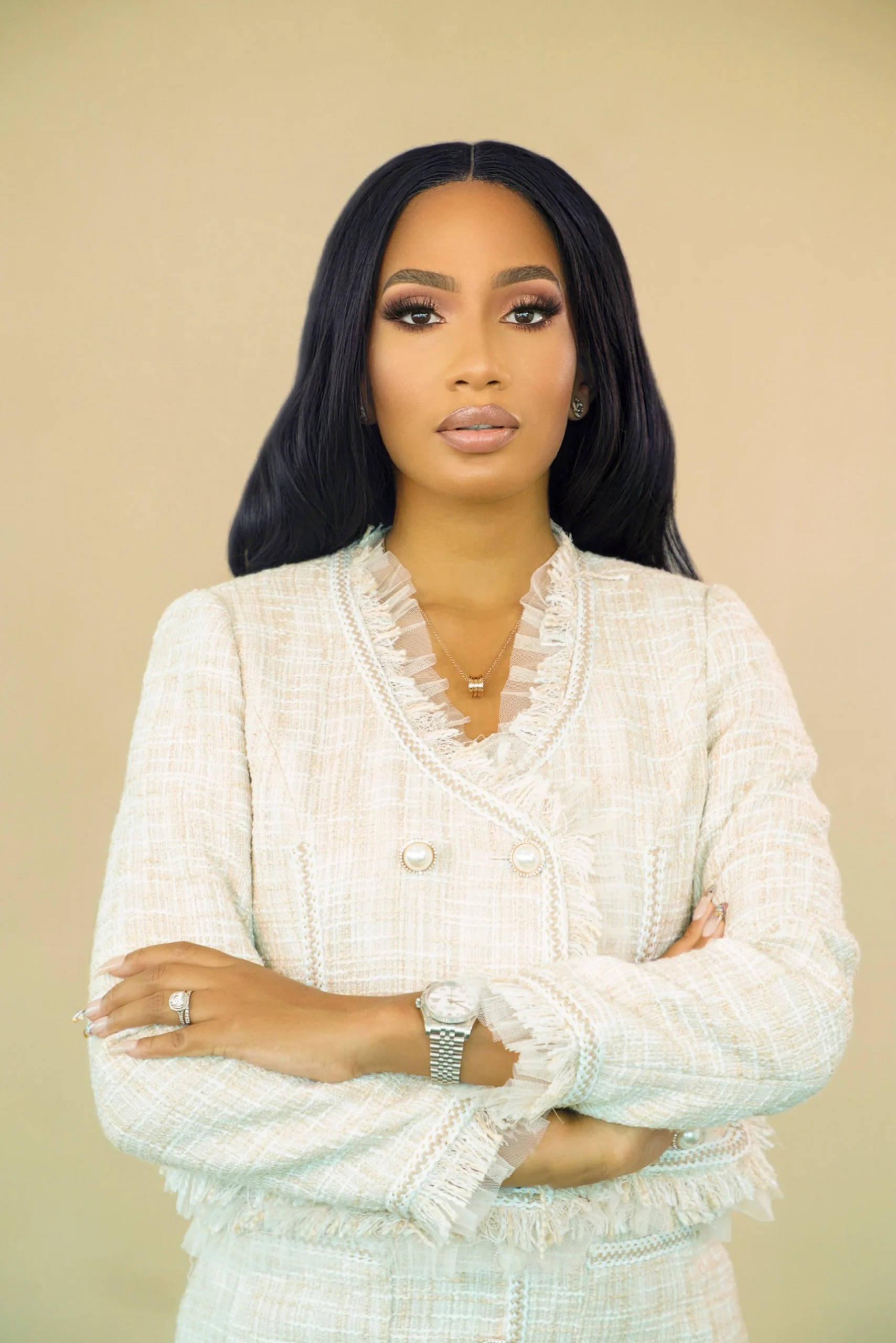 Portrait of Temi Marcella Olatunde in a cream tweed jacket.