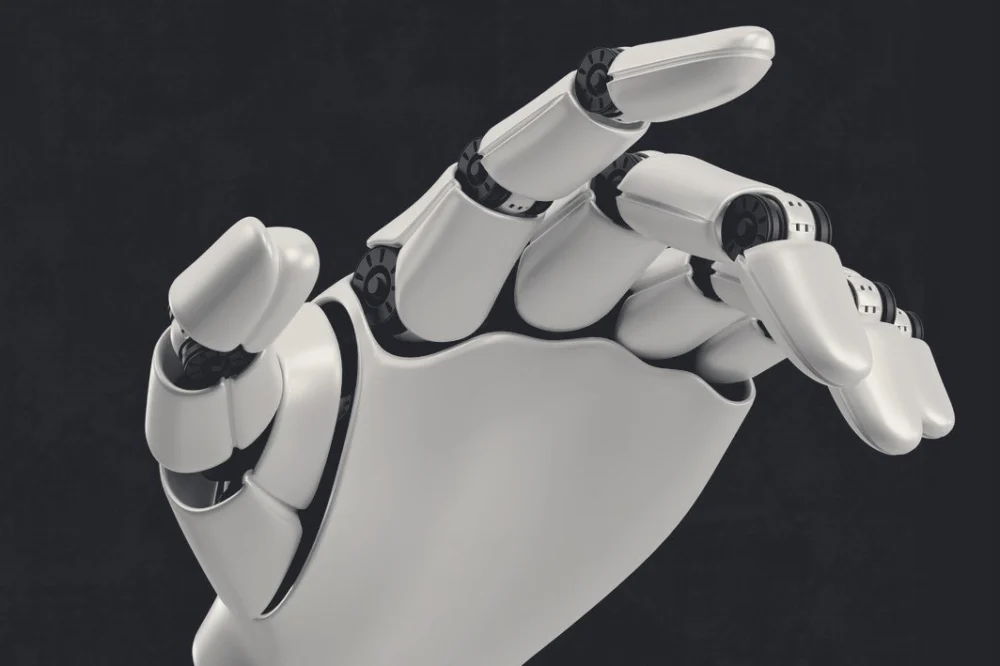 A robotic hand reaching forward against a dark background.