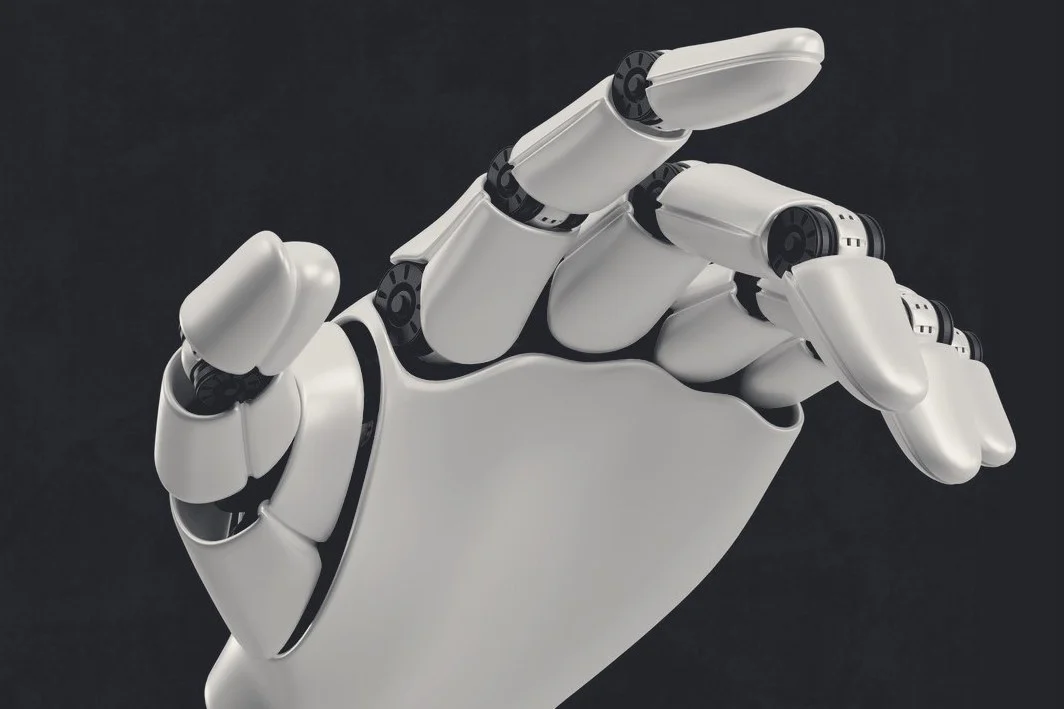 A robotic hand reaching forward against a dark background.